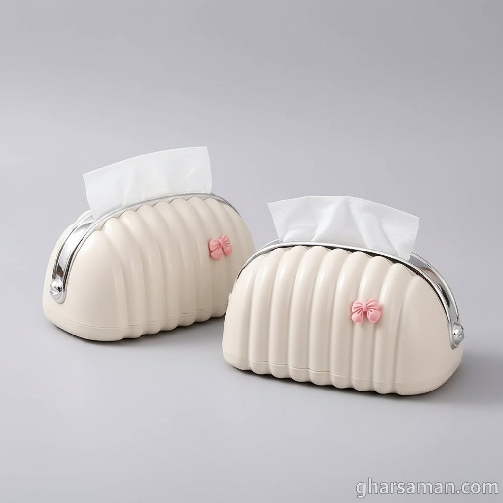 Two white pumpkin-shaped tissue holders with pink flowers on a glass surface.