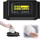 Black container of shoe shine wipes with a hand pulling out a wipe and using it on a shoe.
